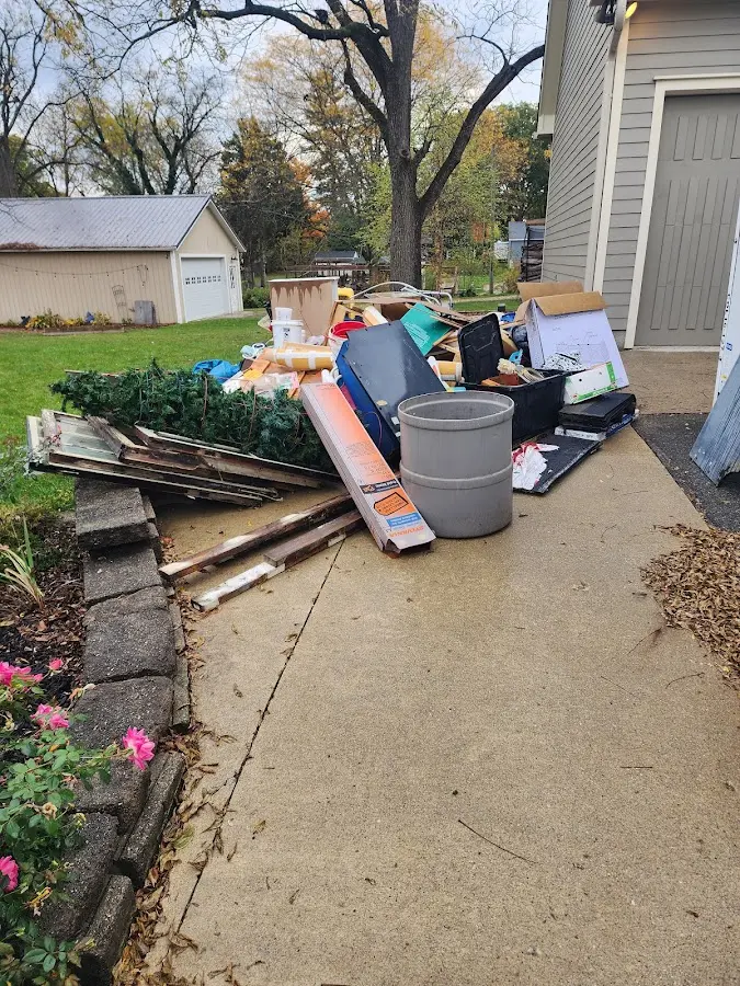 Dumpster being loaded with debris for Roofing Dumpster Rental in Brownfield